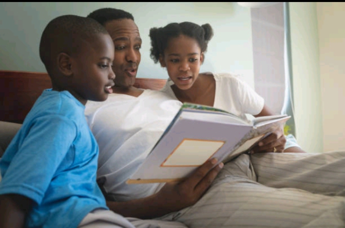 Father reading bedtime stories for his children 